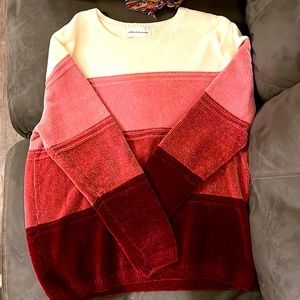 It is a multi Paul color sweater with white pink dark pink and burgundy